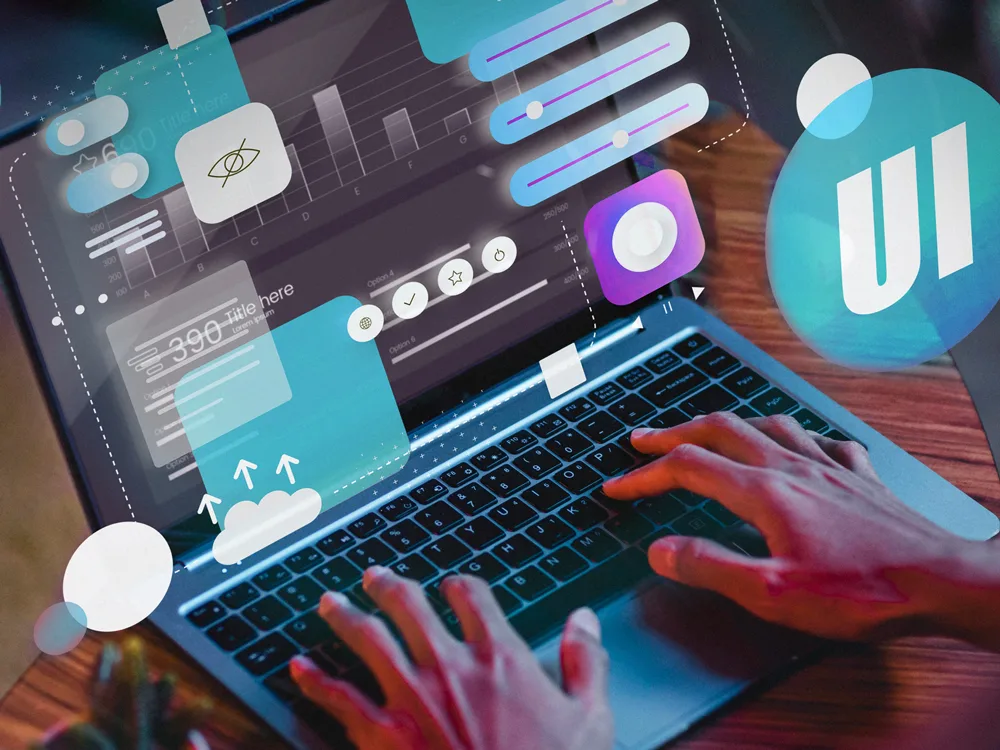 Person using a laptop with graphic user interface elements, including data visualizations, UI design elements, and cloud upload icons.