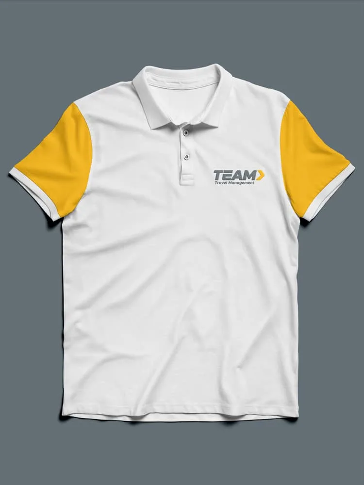 A white and yellow polo shirt with Team Travel Management's logo